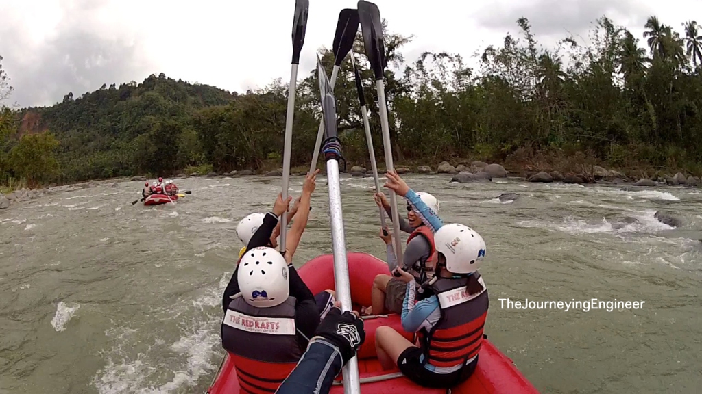 Group of tourists on raft paddle toasting Cagayan de Oro